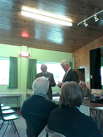 Tony Dyson receiving the Winter Short Lawn Tournament Trophy from Chairman Ron George.