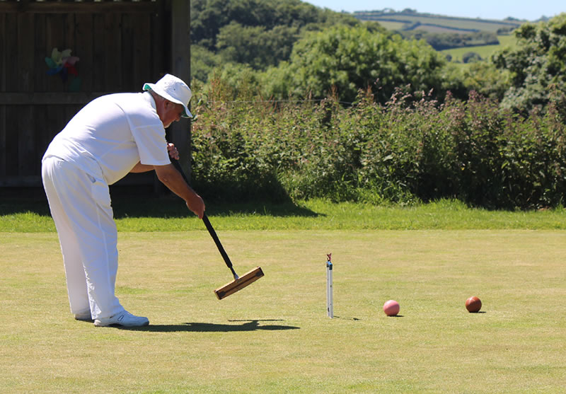 John Paterson (Exeter) runs pink through hoop 1 to start the afternoon singles