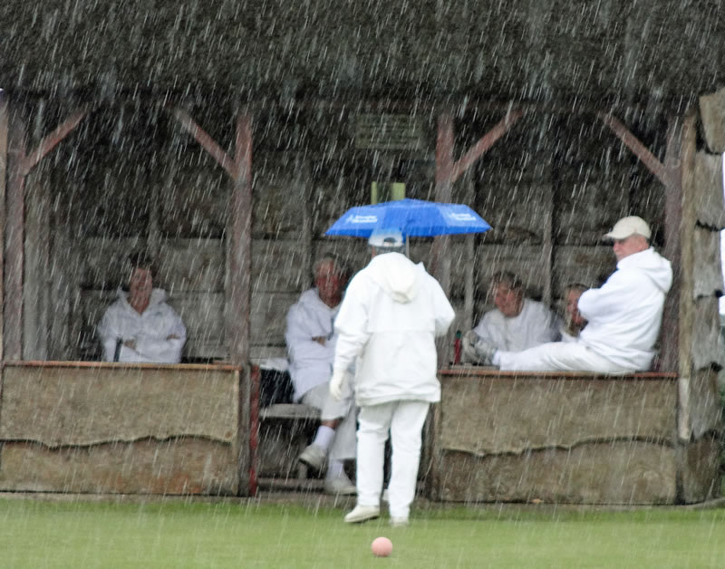 Dorianne braves the downpour to confer!